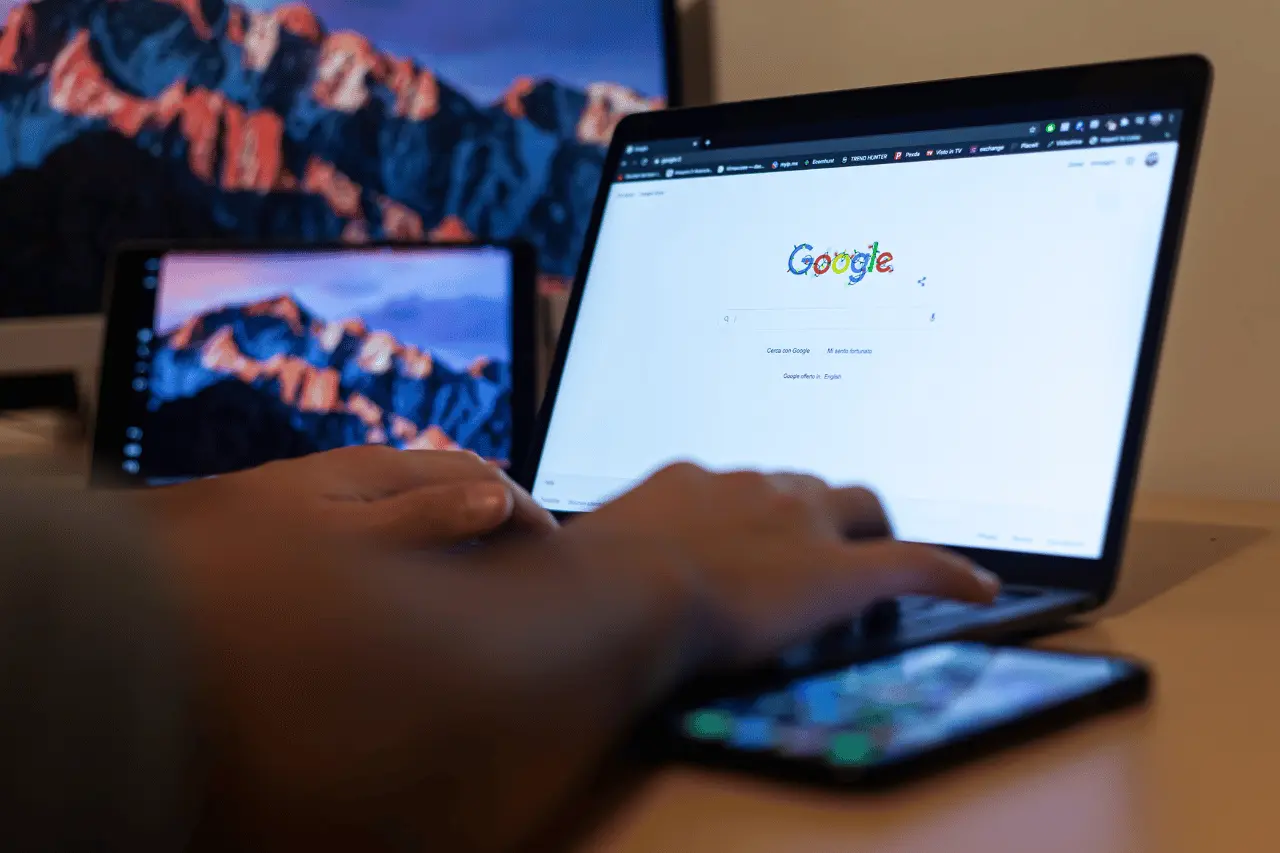 A man looking at the Google homepage on a laptop